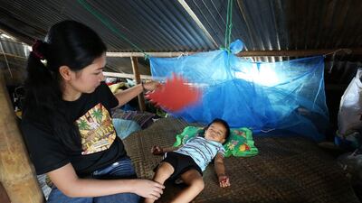 Aiza Tonida watches over her two-year-old Jaizen Jericho Caga. (Joey Reyna for The National / April 9, 2014)