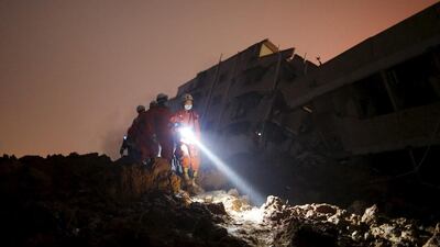 Firefighters search for survivors among the rubble of collapsed buildings after a landslide hit an industrial park in Shenzhen, Guangdong province, China. Tyrone Siu / Reuters