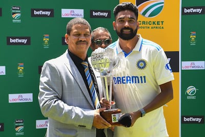 India's Mohammed Siraj, right, is awarded the player of the match trophy after the second Test against South Africa at Newlands on January 4, 2024. AFP