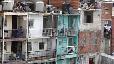 Residents are seen in the Villa 31 slum, which has grown 50 per cent in the past four years to currently house some 40,000 people. A sharp currency devaluation in Argentina in January has worsened one of the world’s highest inflation rates. Enrique Marcarian / Reuters
