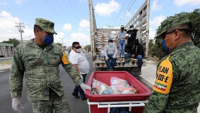 Members of the National Guard deliver supplies part of the health contingency due to COVID-19 in the country, in Cancun, Mexico. EPA