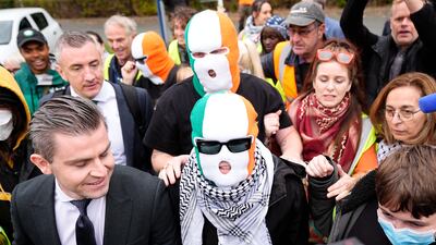 Kneecap's Mo Chara (Liam Og O hAnnaidh), centre, arriving at Woolwich Crown Court, London, on a terror-related charge relating to the display of a flag supporting Hezbollah at a concert. The case was thrown out following a technical error in the way the charge against him was brought. PA