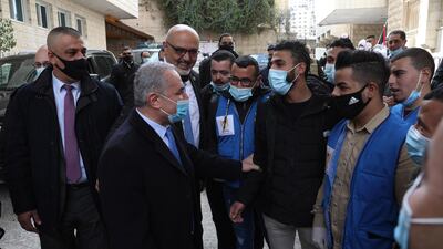 Palestinian Prime Minister Mohammad Shtayyeh talks to medical staff after the opening of Al-Hilal Hospital in the west bank city of Nablus. EPA