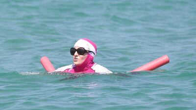 A woman in a "burkini" swims in the sea (Photo by Peter Slane/Papixs via Getty Images)