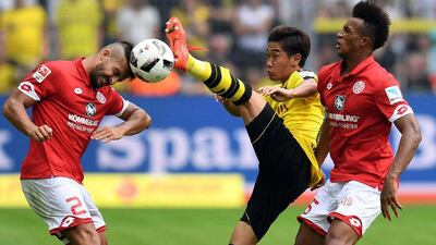 Japan's Shinji Kagawa, centre, in action for his German club side Borussia Dortmund against Mainz in the Bundesliga on Friday, August 27, 2016. The midfielder is in the Japan squad to take on UAE in a 2018 World Cup qualifier on Thursday, September 1, 2016. Patrik Stollarz / AFP