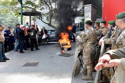 Lebanese soldiers stand guard as bank customers burn tyres in protest against national financial policies outside a Fransabank building in Beirut this month. EPA