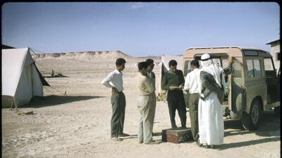 Construction workers at Jebel Dhanna buy bank drafts from a British Bank of the Middle East Land Rover in 1963, to send money home to their families abroad. Photo by David Riley One time use - permission must be sought from desk or David -