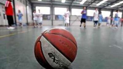 Hoop dreams: Students run drills on the court at Beijing's Weikang basketball school.