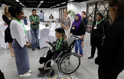 Noura Farag, who uses a wheelchair, attends volunteer training for the Games. Pawan Singh / The National