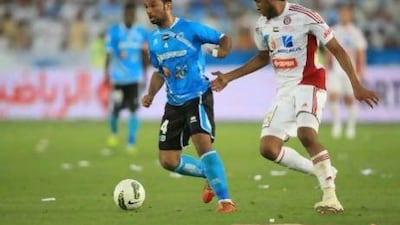 Al Jazira's Khamis Esmail Ahmed Ali Alebri of Baniyas fight for the ball during the President´s Cup final at Zayed Sports City. Ravindranath K / The National