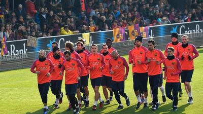 Barcelona players run during a training session at the Mini stadium in Barcelona on January 3, 2017. Lluis Gene / AFP