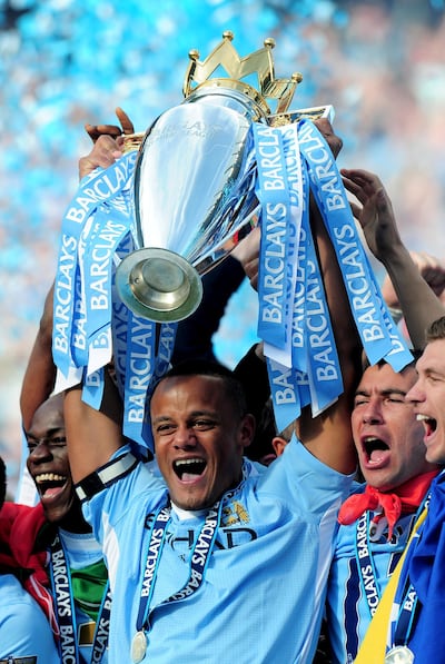 Manchester City captain Vincent Kompany lifts the Premier League trophy after his side clinched the title at the Etihad Stadium on May 13, 2012. Getty