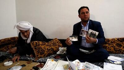 Botan Mahmoud Hassour in Erbil, Iraq, shows his pictures from when he was working with the US military as he awaits his date of travel to the US. as a refugee after President Donald Trump's decision to temporarily bar travellers from seven countries, including Iraq, January 28, 2017. Ahmed Saad / Reuters