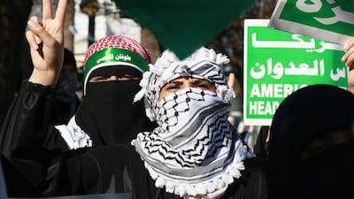 A protester flashing the V for victory sign as people march during a demonstration near the US embassy in the capital Amman in solidarity with the people of Gaza. AFP