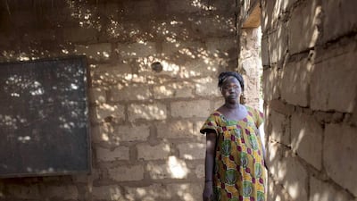 Hadja Aissatu Sanha Maco, the inheritor of land being used for timber exploitation by Chinese businessmen, inside an unfinished classroom her village was promised in Sintchan Companhe. Joe Penney / Reuters