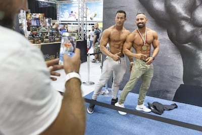Muscle men pose on the show floor at Dubai's World Trade Centre. Antonie Robertson / The National