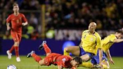 Portugal's Ronaldo tumbles to the ground against Sweden.