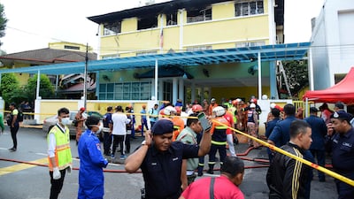 Police and rescue personnel work at an Islamic religious school cordoned off after the fire on the outskirts of Kuala Lumpur. AP Photo