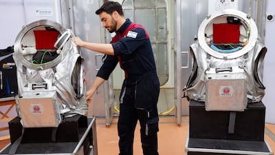 Israeli astronaut Alon Tenzer prepares his spacesuit before starting the training mission in the Negev desert. AFP