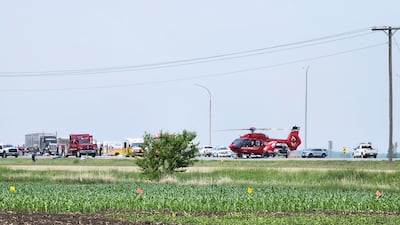 Emergency workers and a medi-vac helicopter at the scene of the deadly accident in the town of Carberry, Manitoba. EPA