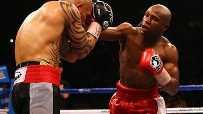 LAS VEGAS, NV - MAY 05: (R-L) Floyd Mayweather Jr. throws a right to the head of Miguel Cotto during their WBA super welterweight title fight at the MGM Grand Garden Arena on May 5, 2012 in Las Vegas, Nevada. Al Bello/Getty Images/AFP== FOR NEWSPAPERS, INTERNET, TELCOS & TELEVISION USE ONLY ==