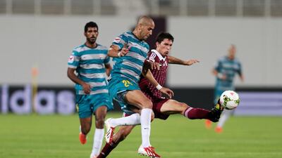 Al Wahda's Sebastian Tagliabue, right, and Fujairah's Madjid Bouguerra battle for the ball during their Arabian Gulf League match at Al Nayhan Stadium in Abu Dhabi on October 27, 2014. Christopher Pike / The National