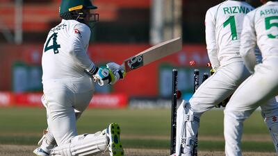 Australia batter Alex Carey, left, is bowled out by Pakistan's Babar Azam. AP
