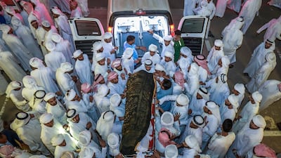 Mourners at the funeral of Ali Al Ketheri's family at Baniyas Cemetery after eight people, six of them children, died in a fire on Tuesday, October 2. Victor Besa / The National
