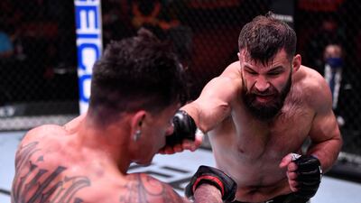 Julian Marquez, right, punches Maki Pitolo in their middleweight fight during the UFC 258 event at UFC APEX in Las Vegas, Nevada. Jeff Bottari / Zuffa LLC / UFC