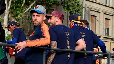 Jordi Alba, left, and his teammates during the open top bus parade celebrating Barcelona's Primera Liga title victory. Lluis Gene / AFP