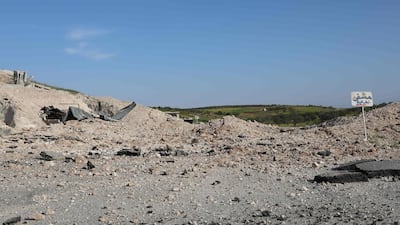 A sign shows the way to a heavily damaged underground hospital in Hass. AFP