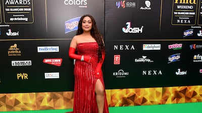 Neha Kakkar Singh in a red gown with matching gloves and shoes. AFP
