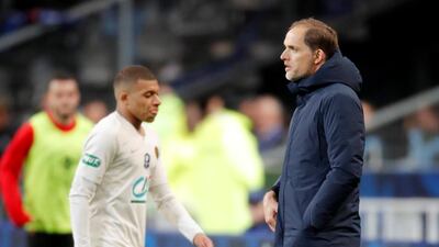 PSG manager Thomas Tuchel looks on as Kylian Mbappe walks past him after being sent off. Charles Platiau / Reuters