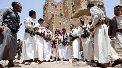 Yemenis gather to pose for a picture as they visit a historic site during the , at the Dar al-Hajar (Rock Palace) valley on the outskirts of Sana'a, Yemen. Yahya Arhab / EPA
