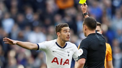 Tottenham Hotspur's Harry Winks is shown a yellow card by referee Stuart Attwell in the home defeat to Wolves. Reuters