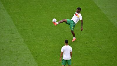 Cameroon defender Christopher Wooh traps the ball during the warm up for the Group G match against Switzerland. AFP
