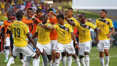 Juan Cuadrado of Colombia, centre, celebrates with teammates after scoring his team's first goal to go up 1-0 against Japan on Tuesday at the 2014 World Cup in Cuiaba, Brazil. Mark Kolbe / Getty Images