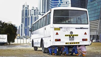 Construction workers seek shelter from the rain under a bus in Dubai. A reader observes that it demonstrates poor attention to the safety of workers and urges a safer approach to the welfare of labourers. Photo: Sarah Dea / The National