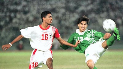Saudi Arabia forward Hussein Omar clears the ball away from UAE defender Hassan Ahmed during the final in Abu Dhabi. Saudi Arabia won the match on penalties, and were crowned champions of Asia. AFP