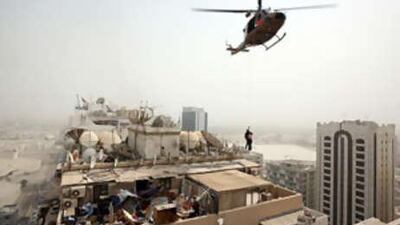 A woman is rescued from the top of an apartment building that caught fire this week.