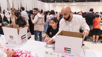 Volunteers pack aid for Palestine at an event Dubai last week. Antonie Robertson / The National