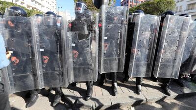 Tunisian anti-riot policemen block the way in front of protesters during a demonstration in Tunis. EPA