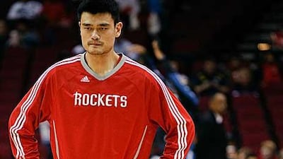 Yao Ming looks forlorn as he waits for medical attention.