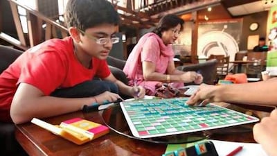 Sanchit Kapoor, 12, will be competing in the 7th annual World Youth Scrabble Championships with two other UAE teammates in Birmingham, UK from December 7th-9th. Kapoor is seen here practicing with his teammates at the Tea Junction Cafe in Oud Metha. Jeff Topping / The National