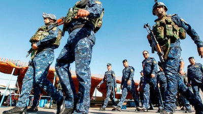Policemen secure the area on the outskirts of Baghdad. AFP