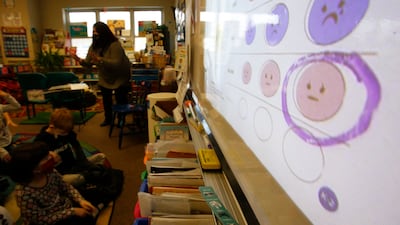Second-grade teacher Melissa Shugg teaches a lesson at Paw Paw Elementary School about thoughts, feelings and actions on December 2, 2021, in a school in, Michigan, US. Shugg is one of many teachers at the school who've been trained to teach a social-emotional curriculum created at the University of Michigan called TRAILS. Research suggests TRAILS lessons for at-risk kids can reduce depression and improve coping skills. AP