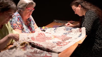 Embroiderers work on the final section of a tapestry depicting the hit television series Game of Thrones at the Ulster Museum in Belfast. Like the Bayeux Tapestry, the Game of Thrones Tapestry is woven of fine linen and hand-embroidered, with decorative borders and a central pictorial narrative. It will reach 90m by the end of the final season of the show. AFP