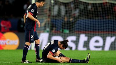 Thiago Motta, left, checks on Zlatan Ibrahimovic, ground, after he gets hurt during Wednesday's Champions League victory over Chelsea. Shaun Botterill / Getty Images