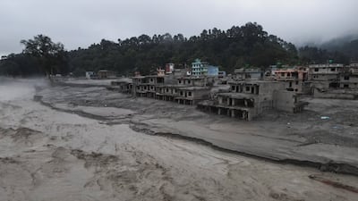 The Trishuli River flowing past damaged buildings covered in mud after the deadly flash floods and mudslide. Reuters