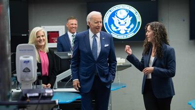 US President Joe Biden speaks with the Director of the National Counterterrorism Centre, Christine Abizaid. Photo by SAUL LOEB / AFP